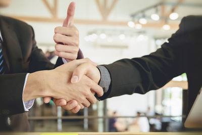 Midsection of man holding hands