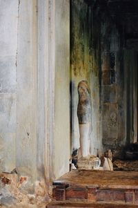 Statue against old building