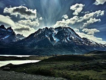 Scenic view of snowcapped mountain against cloudy sky