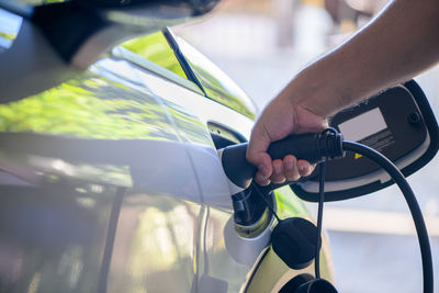 Cropped hand of man holding car