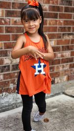 Portrait of smiling girl with astros jersey