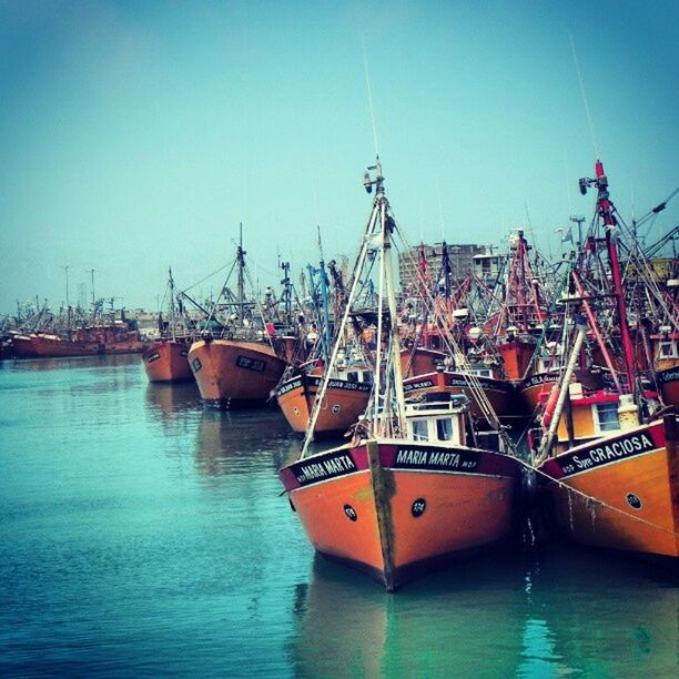 nautical vessel, boat, transportation, clear sky, water, mode of transport, moored, waterfront, sea, harbor, blue, built structure, copy space, architecture, ship, building exterior, mast, commercial dock, river, crane - construction machinery