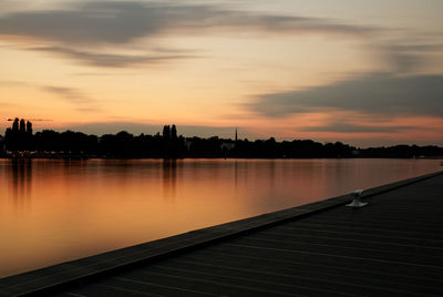 Scenic view of lake against orange sky