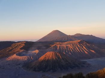 Scenic view of mountains against clear sky during sunset