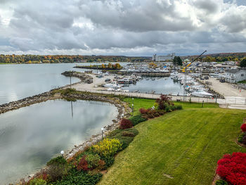 High angle view of river amidst field against sky