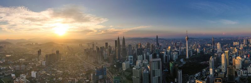 Panoramic shot of city against sky during sunset