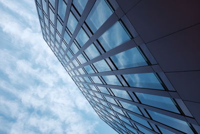 Low angle view of modern building against blue sky