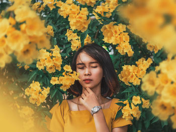 Portrait of woman with yellow flowers