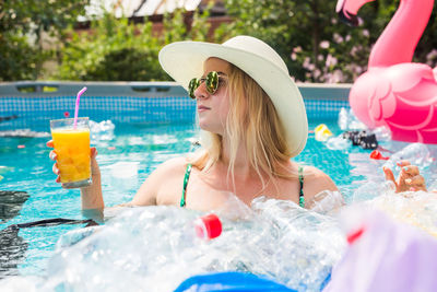 Portrait of woman with ice cream in swimming pool