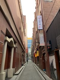 Street amidst buildings against sky in city