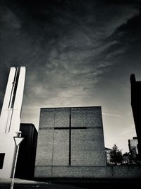 Low angle view of silhouette building against sky