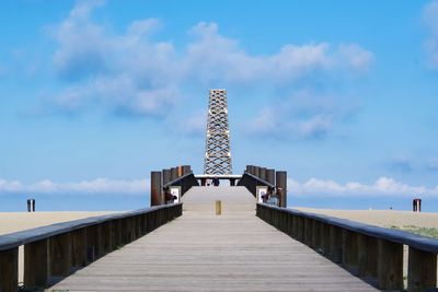 Footpath by building against sky