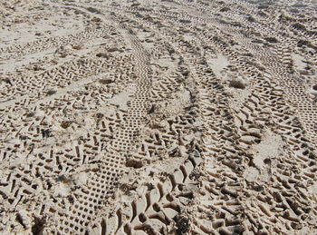 Full frame shot of tire tracks on sand