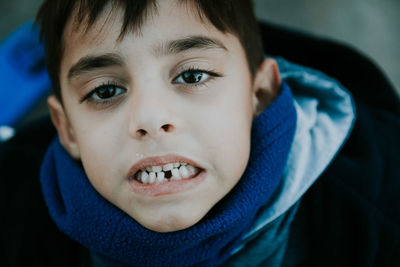 High angle portrait of cute boy showing gap toothed