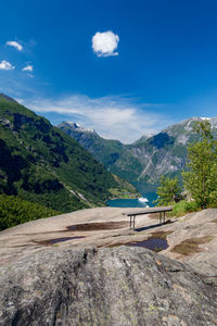 Scenic view of landscape and mountains against blue sky