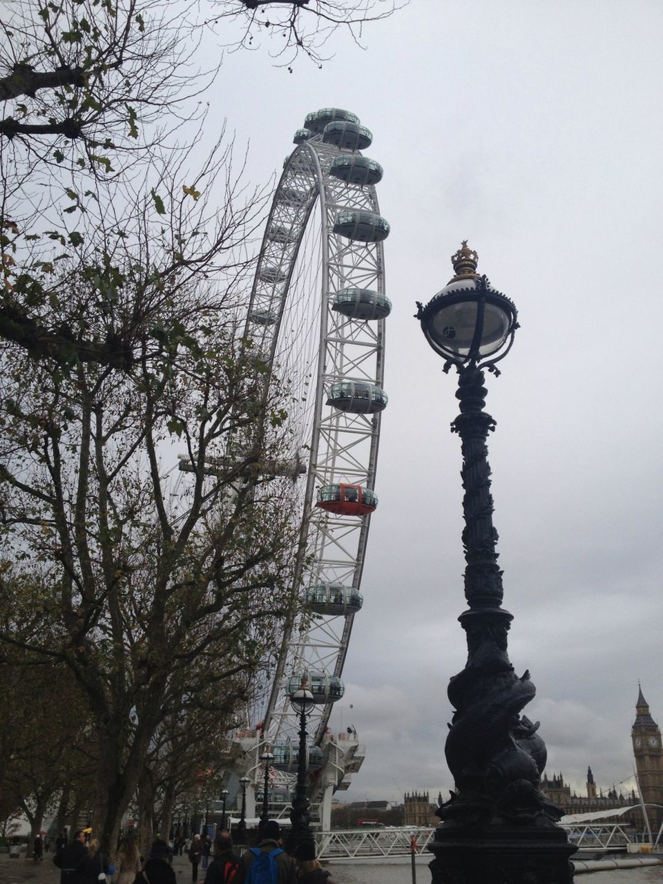 low angle view, tree, architecture, built structure, street light, sky, building exterior, lighting equipment, travel destinations, famous place, sculpture, tourism, city, art and craft, arts culture and entertainment, outdoors, amusement park, amusement park ride, day, statue