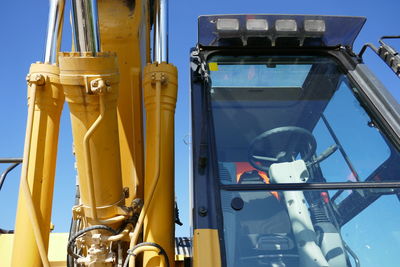 Low angle view of earth mover against sky