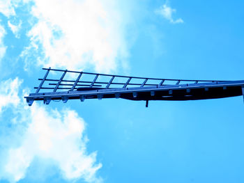 Low angle view of windmill against blue sky