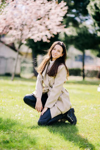 Portrait of woman sitting on field