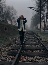 Full length of woman on railroad track
