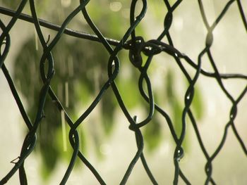 Close-up of chainlink fence against sky