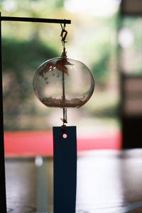 Close-up of electric lamp hanging on metal