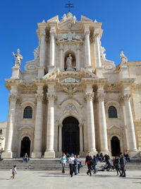 Group of people in front of historical building