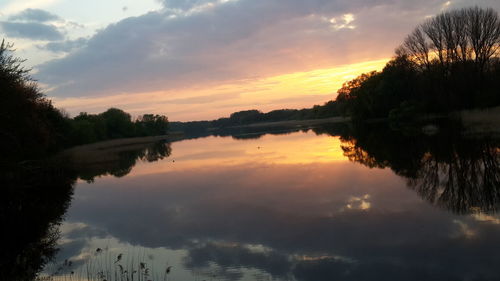 Scenic view of lake against sky during sunset