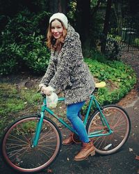 Portrait of young woman on bicycle