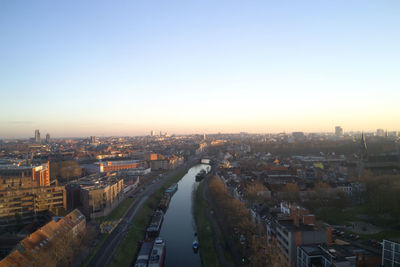 High angle view of city buildings against clear sky