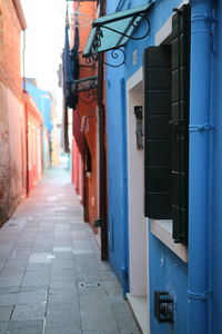 Footpath amidst buildings in city