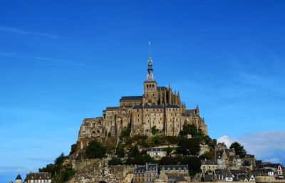 Low angle view of historic building against blue sky