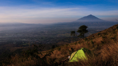 Scenic view of landscape against cloudy sky