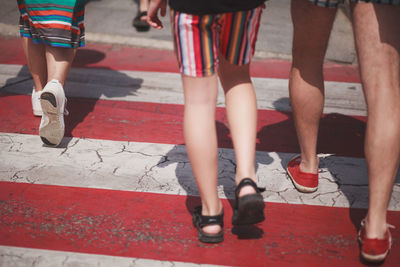 Low section of people walking on road