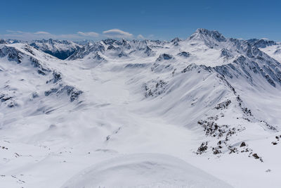 Scenic view of snow covered mountains against sky