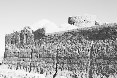 Tilt image of people on snowcapped mountain against sky