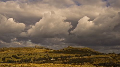 Scenic view of mountains against cloudy sky