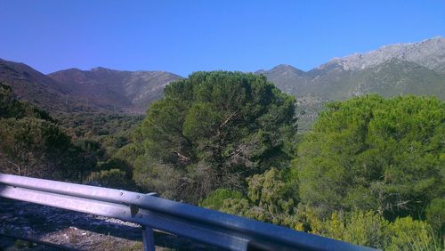 Scenic view of mountains against blue sky