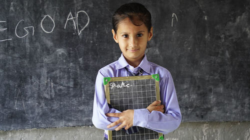 Portrait of young man using digital tablet at home