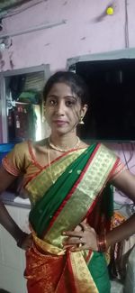 Portrait of smiling woman standing at home