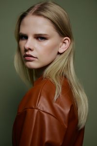 Close-up of young woman against wall