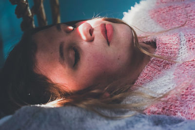 Close-up of woman lying on bed