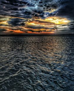 Scenic view of sea against cloudy sky