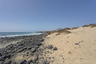 Scenic view of beach against clear sky