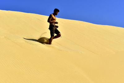 Full length of man in desert against clear sky