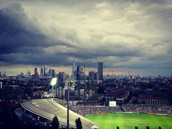 Cityscape against cloudy sky