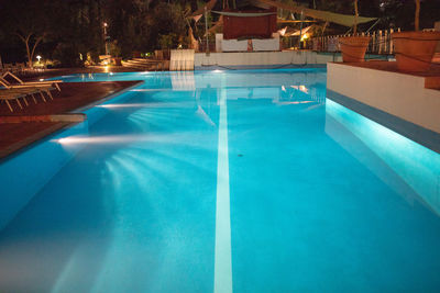 Reflection of chairs on swimming pool