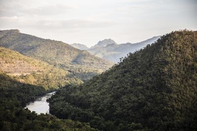 Scenic view of river amidst mountains against sky