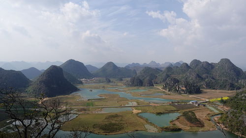 Scenic view of lake and mountains against sky