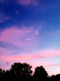 Low angle view of silhouette trees against sky at sunset